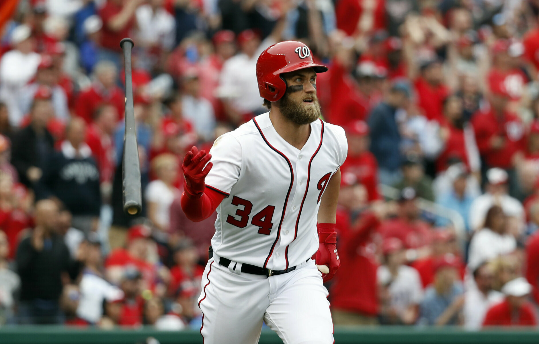 Washington Nationals' Bryce Harper flips his bat as he watches his solo home run during the sixth inning of an opening day baseball game against the Miami Marlins, at Nationals Park, Monday, April 3, 2017, in Washington. (AP Photo/Alex Brandon)