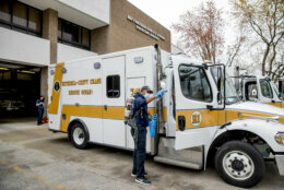Volunteer EMT Ronald Felix, a full time police officer for Montgomery County, Md., sanitizes an ambulance at Bethesda-Chevy Chase Rescue Squad, Saturday, April 4, 2020, in Bethesda, a suburb of Washington. (AP Photo/Andrew Harnik)