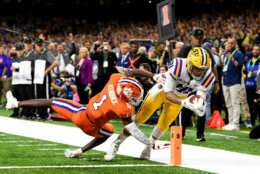 NEW ORLEANS, LA - JANUARY 13: Thaddeus Moss #81 of the LSU Tigers scores a touchdown against Derion Kendrick #1 of the Clemson Tigers during the College Football Playoff National Championship held at the Mercedes-Benz Superdome on January 13, 2020 in New Orleans, Louisiana. (Photo by Jamie Schwaberow/Getty Images)