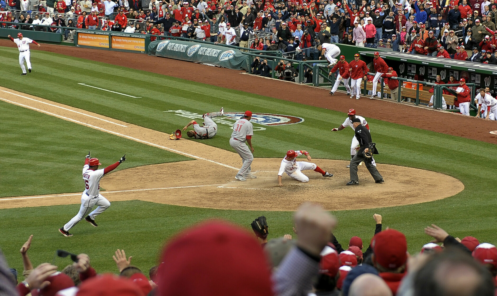 WASHINGTON, DC - APRIL 12: 
Washington Nationals' Ryan Zimmerman slides in to home plate winning the game in the tenth inning after a wild pitch by Cincinnati Reds' Alfredo Simon during opening day at Nationals Park on April 12, 2012 in Washington, D.C. The Nationals beat the Reds 3-2. (Photo by Ricky Carioti/The Washington Post via Getty Images)