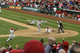 WASHINGTON, DC - APRIL 12: 
Washington Nationals' Ryan Zimmerman slides in to home plate winning the game in the tenth inning after a wild pitch by Cincinnati Reds' Alfredo Simon during opening day at Nationals Park on April 12, 2012 in Washington, D.C. The Nationals beat the Reds 3-2. (Photo by Ricky Carioti/The Washington Post via Getty Images)