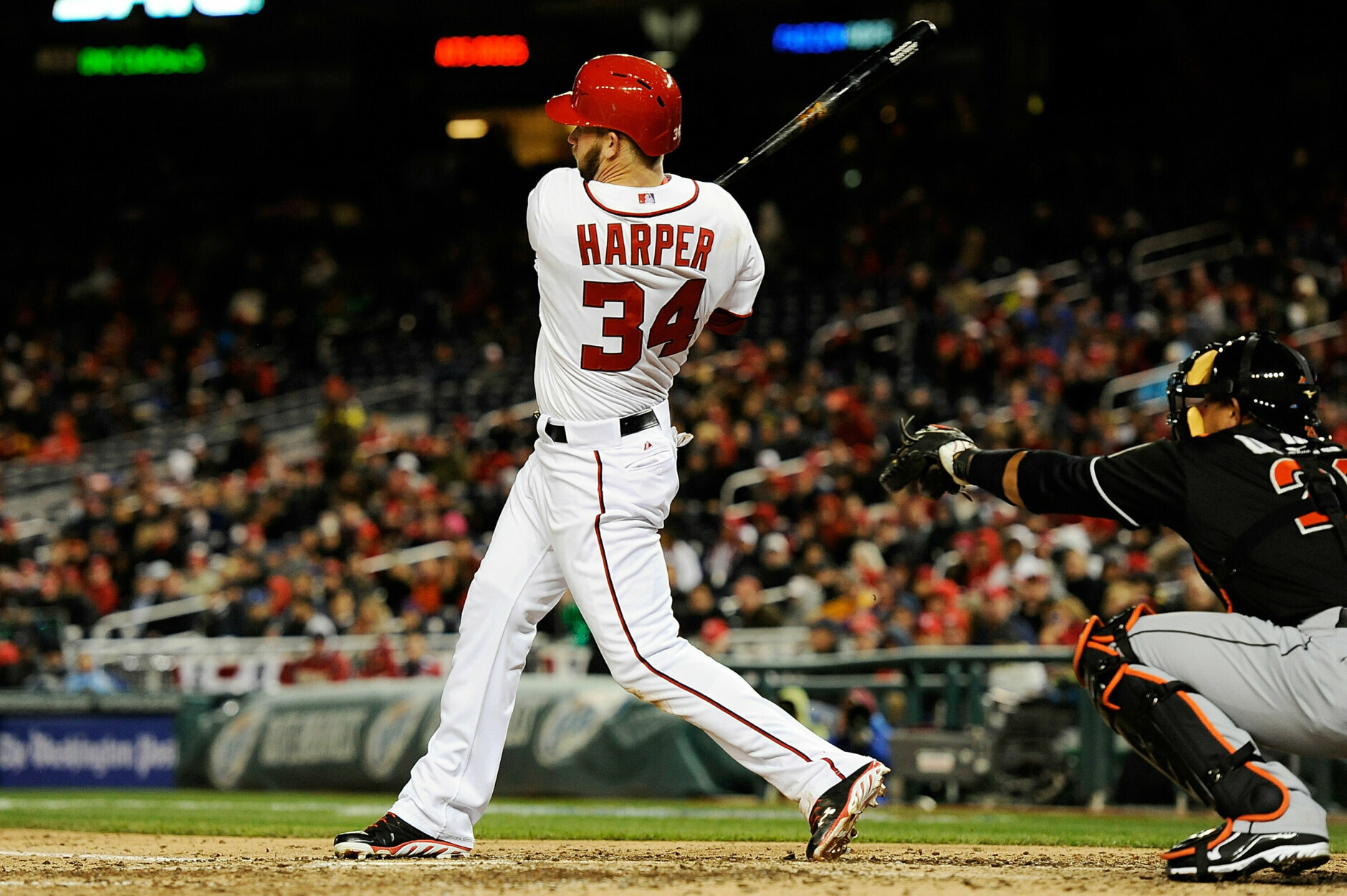 WASHINGTON, DC - APRIL 03:  Bryce Harper #34 of the Washington Nationals hits a double to right field in the eighth inning during a game against the Miami Marlins at Nationals Park on April 3, 2013 in Washington, DC. The Nationals defeated the Marlins 3-0. (Photo by Patrick McDermott/Getty Images)