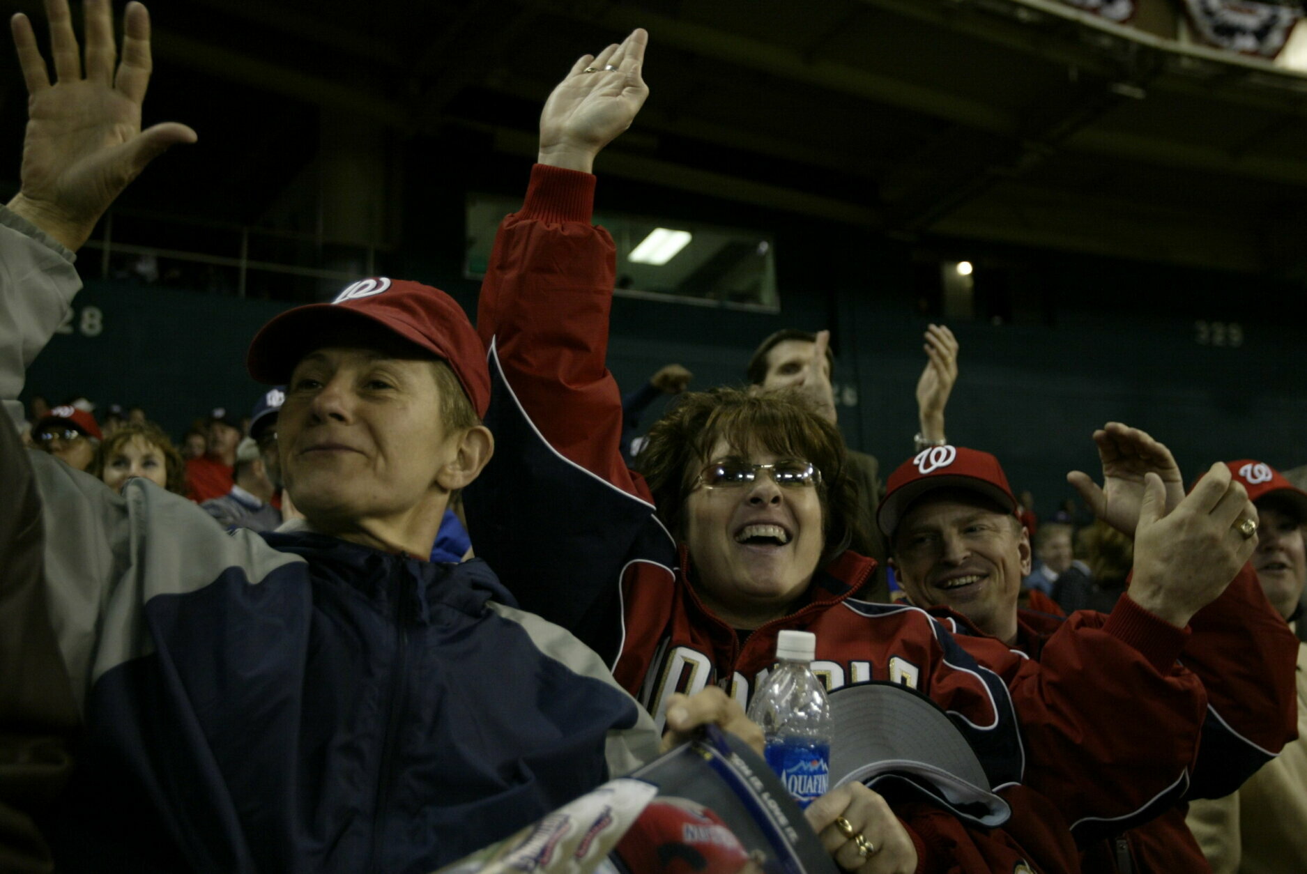 WASHINGTON - APRIL 14:  Unidentified fans of the Washington Nationals react to a home run by Vinny Castilla at RFK Stadium on April 14, 2005 in Washington, D.C. The Nationals defeated the Diamondbacks 0-0. (Photo by Paul Cunningham/MLB via Getty Images)