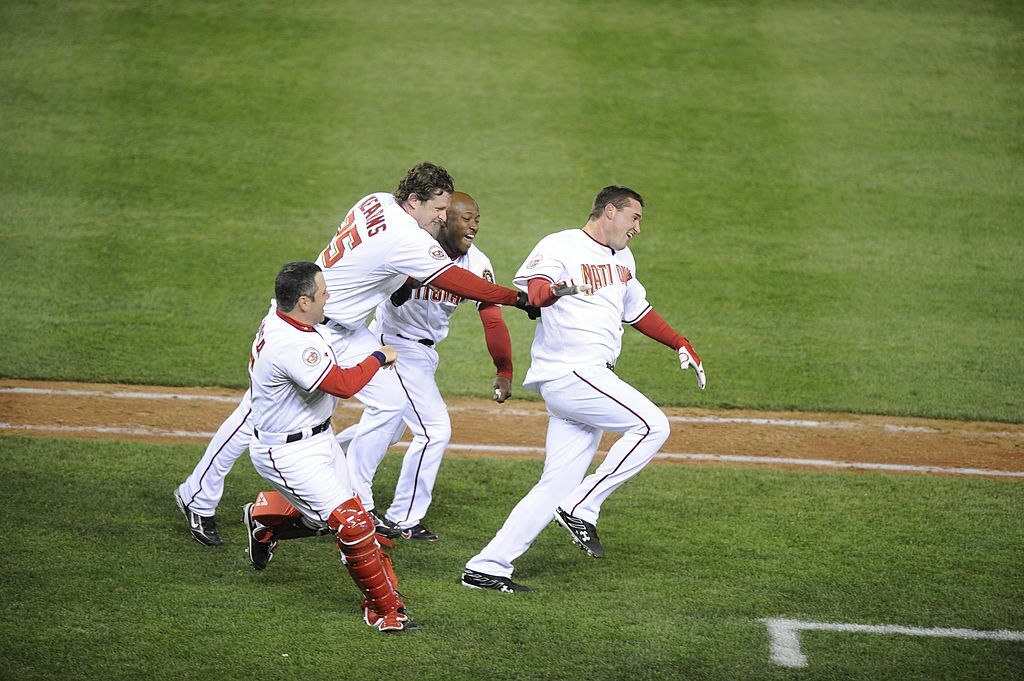 WASHINGTON - MARCH 30:  Ryan Zimmerman #11 of the Washington Nationals celebrates with teammates after hitting the game winning home-run in the bottom of the 9th inning against the Atlanta Braves on opening day on March 30, 2008 at Nationals Park in Washington, D.C. The Nationals won 3-2. (Photo by G Fiume/Getty Images)
