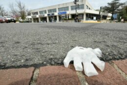 <p>A disposable glove blows along the curb of Connecticut Avenue, Northwest, in Chevy Chase. (WTOP/Dave Dildine)</p>

