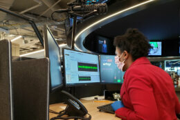 Female journalist working in the WTOP newsroom.