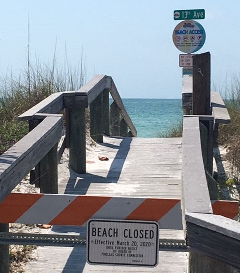 Sign stating a Florida beach is closed.