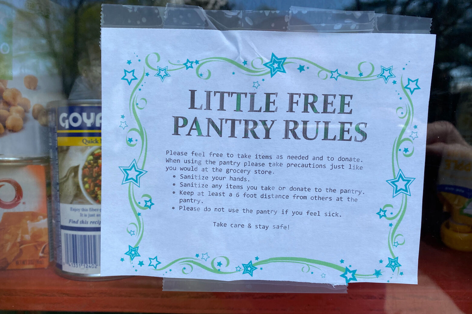 SIgn posted on the front of a little free library box