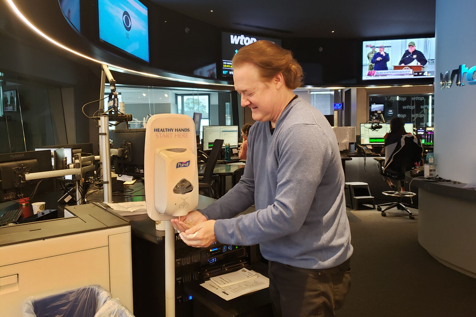 WTOP Afternoon Anchor Shawn Anderson using the newsroom's Purell station.