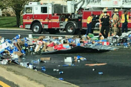 Containers of beer spilled on roadway.