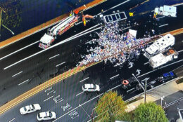 Emergency vehicles responding to an overturned truck carrying beer.