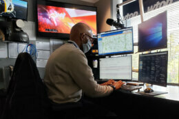 Male journalist updating information in the WTOP traffic center.