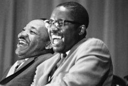 Civil rights leader Martin Luther King Jr., left, and Tuskegee attorney Fred Gray break into laughter at a joke told by a speaker at a political rally in Tuskegee, Alabama, April 29, 1966. Rev. King is on a whistle-stop tour through Alabama to encourage block-voting by blacks in the May 3 Alabama primary. Gray is a candidate for a seat in the Alabama House of Representatives. (AP Photo/Jack Thornell)