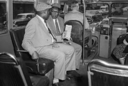Two unidentified black men sit in the first seat behind the driver of a city bus in Montgomery, Al, Dec. 21, 1956, after the supreme court ruled racial segregation city on the buses as unconstitutional.  The federal court order ended the Montgomery bus boycott, which lasted 381 days.  (AP Photo)
