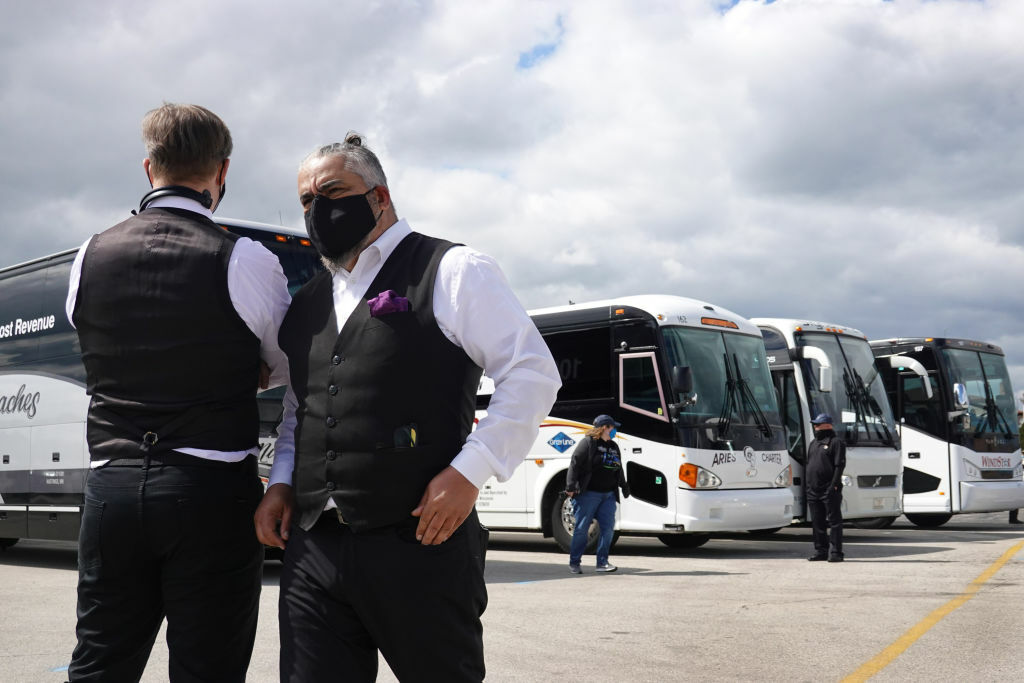 ROSEMONT, ILLINOIS - MAY 11: Motor coach owners and drivers rendezvous near O'Hare Airport on May 11, 2020 in Rosemont, Illinois. The owners and drivers will be departing in a caravan to Washignton, D.C. where they will join an anticipated 400+ other coaches for the Motorcoaches Rolling for Awareness rally expected to take place Wednesday. The operators are hoping to draw attention to the industry's need for $15 billion in grants and loans after the COVID-19 pandemic caused a 95 percent drop business. About 90 percent of the coach businesses in the United States are small family-owned businesses.  (Photo by Scott Olson/Getty Images)