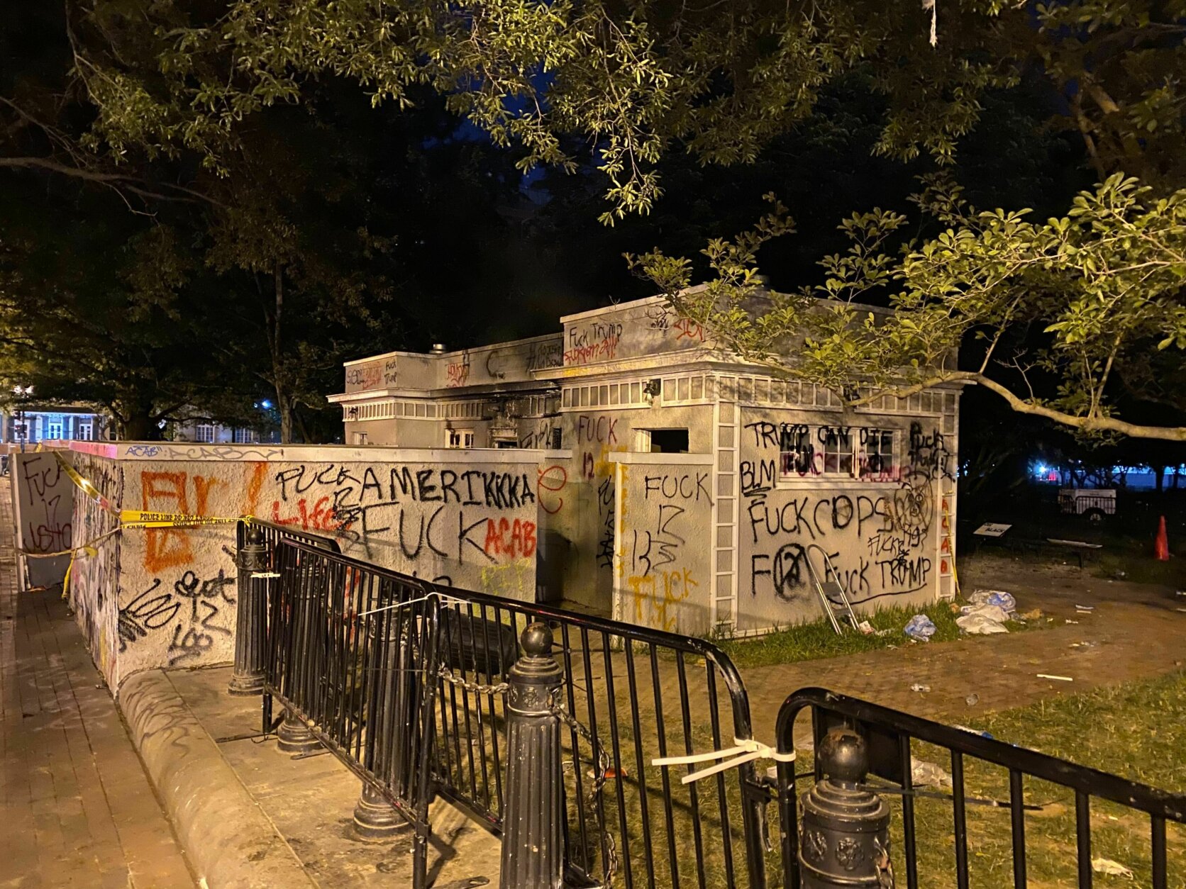<p>A building is seen covered in graffiti near 16th Street NW in D.C. following protests. (John Domen/WTOP)</p>
