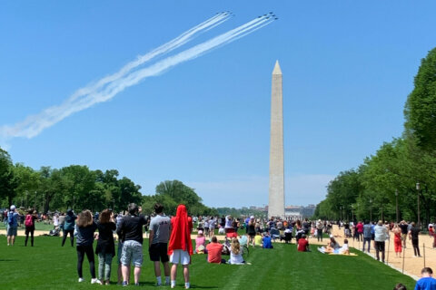 Military jets flyover the Washington Monument