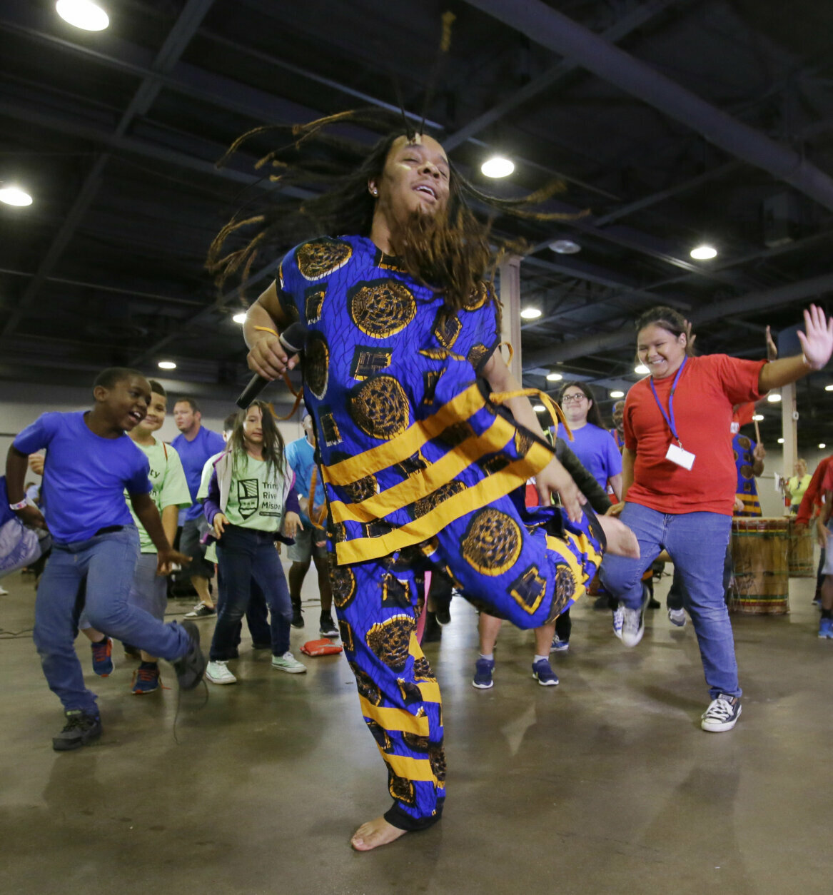 T.J. with the Bandan Koro African Dance Ensemble leads children dancing during a Juneteenth celebration at Fair Park in Dallas, Monday, June 19, 2017. Juneteenth celebrates the end of slavery in Texas. (AP Photo/LM Otero)