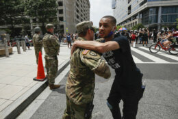 A demonstrator hugs a National Guard soldier during a protest Saturday, June 6, 2020, in Washington, over the death of George Floyd, a black man who was in police custody in Minneapolis. Floyd died after being restrained by Minneapolis police officers. (AP Photo/Alex Brandon)