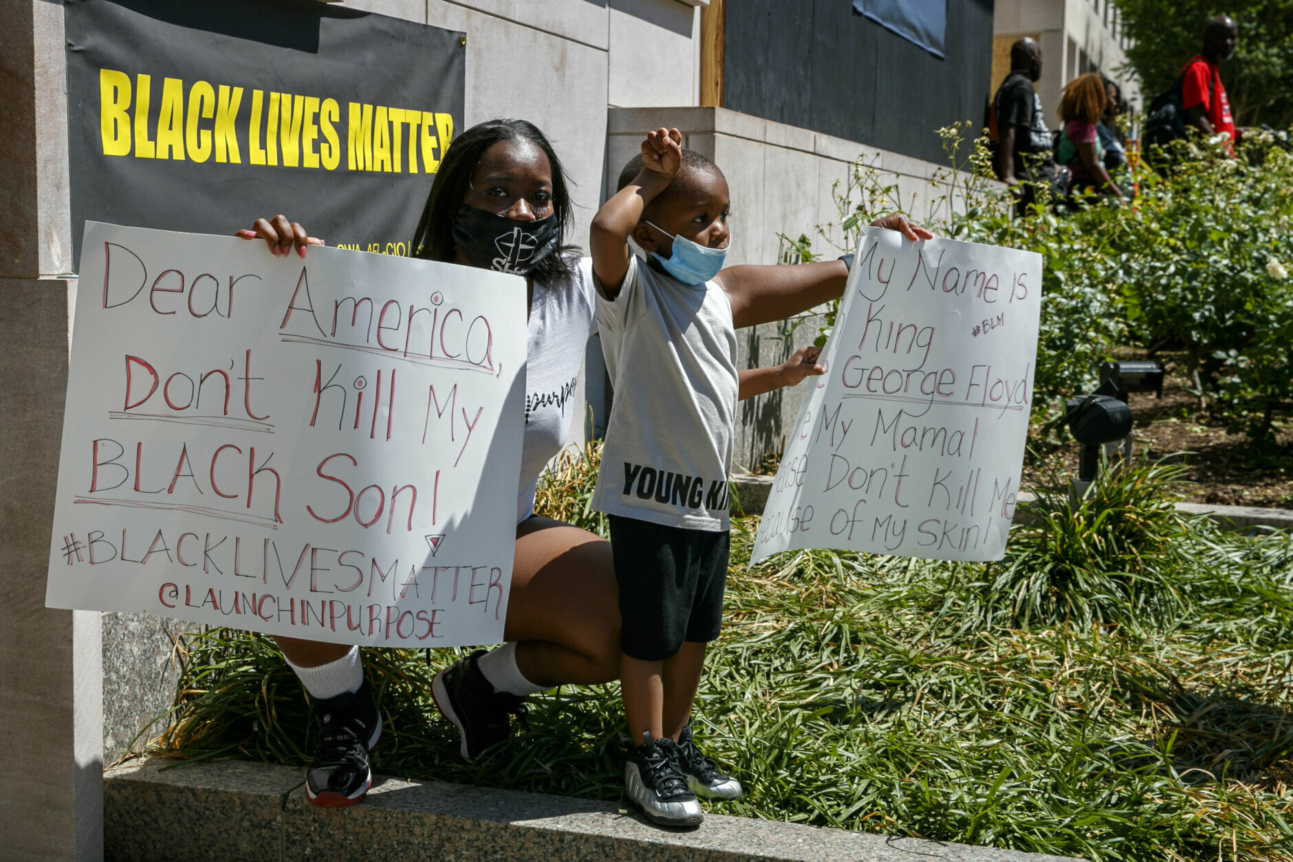 Eileen Perry, of Washington, and her son Micah Coleman, 3, attend a protest, Sunday, June 7, 2020, near the White House in Washington, over the death of George Floyd, a black man who was in police custody in Minneapolis. Floyd died after being restrained by Minneapolis police officers. "Our ancestors marched for us to have equality," says Perry, "this is history now as well and I wanted my kids to see that." (AP Photo/Jacquelyn Martin)