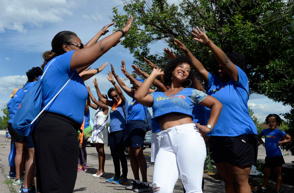 DENVER, CO - JUNE 17: Before the start of the parade, Christina Hughes, center, and other members of GirlTrek rehearse their moves. Participants in the Juneteenth Music Festival and parade make their way down E. 26th Ave. on June 17, 2017 in Denver, Colorado. Organizers say its one of Denver's longest running parades dating back to the 1950's where "nearly 3,000 people march to honor the struggles and social progress achieved through marches and demonstrations organized for freedom, justice, and equality in our countrys history". This year's theme for the event is Dream Big. (Photo by Kathryn Scott/The Denver Post via Getty Images)