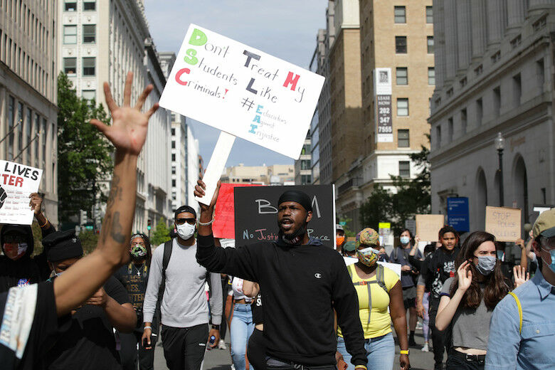 WASHINGTON, USA - JUNE 2: People hold banners during a protest over the death of George Floyd, an unarmed black man who died after being pinned down by a white police officer in Minneapolis, United States on June 2, 2020 in Washington, United States. (Photo by Yasin Ozturk/Anadolu Agency via Getty Images)