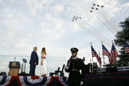 President Donald Trump and first lady Melania Trump watch as the U.S. Air Force Thunderbirds and U.S. Navy Blue Angels perform a flyover during a "Salute to America" event on the South Lawn of the White House, Saturday, July 4, 2020, in Washington. (AP Photo/Patrick Semansky)