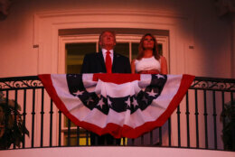 President Donald Trump and first lady Melania Trump stand on the Truman Balcony of the White House as they watch a fireworks display during a "Salute to America" event, Saturday, July 4, 2020, in Washington. (AP Photo/Patrick Semansky)