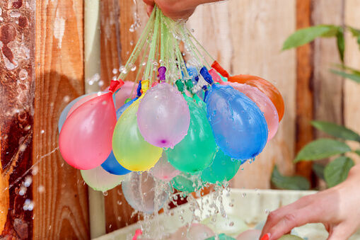 Filling colorful  water balloons with water