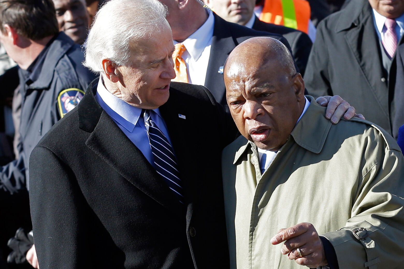 FILE - In this March 3, 2013, file photo, Vice President Joe Biden, left, embraces U.S. Rep. John Lewis, D-Ga., as they prepare to lead a group across the Edmund Pettus Bridge in Selma, Ala. Civil rights icon Lewis is backing Biden for president, giving the prospective Democratic nominee perhaps his biggest symbolic endorsement among the many veteran black lawmakers who back his candidacy. â€œWe need his voice,â€ the 80-year-old Lewis told reporters ahead of the campaign's Tuesday, April 7, 2020 announcement. (AP Photo/Dave Martin, File)