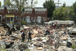BALTIMORE, MARYLAND - AUGUST 10: First responders dig through the rubble of three houses demolished by a gas explosion on August 10, 2020 in Baltimore, Maryland. A gas leak caused the massive explosion that leveled three homes, resulting in multiple injuries and at least one fatality. (Photo by J. Countess/Getty Images)