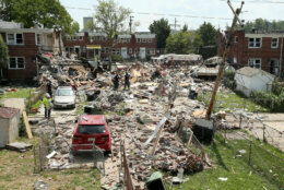 BALTIMORE, MARYLAND - AUGUST 10: First responders dig through the rubble of three houses demolished by a gas explosion on August 10, 2020 in Baltimore, Maryland. A gas leak caused the massive explosion that leveled three homes, resulting in multiple injuries and at least one fatality. (Photo by J. Countess/Getty Images)