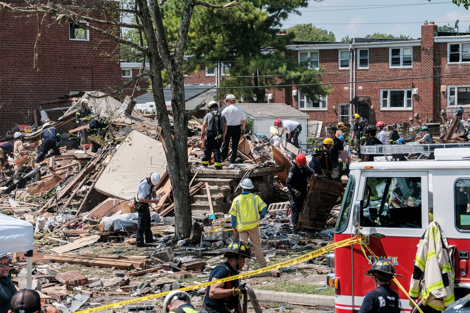 BALTIMORE, MD - AUGUST 10: First responders search for survivors at the scene of an explosion on August 10, 2020 in Baltimore, Maryland. Early reports indicate that a gas leak may have caused the massive explosion that leveled three homes, causing multiple injuries and at least one fatality. (Photo by Michael A. McCoy/Getty Images)