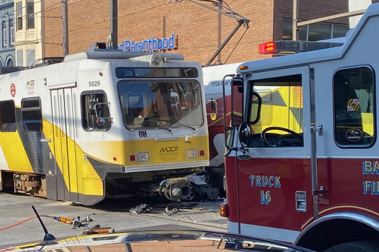 A woman was killed, and two others were injured, including a child, when a car became wedged between two Maryland Transit Administration light rail trains in downtown Baltimore Thursday morning, according to authorities. (Courtesy Baltimore Firefighters IAFF Local 734)