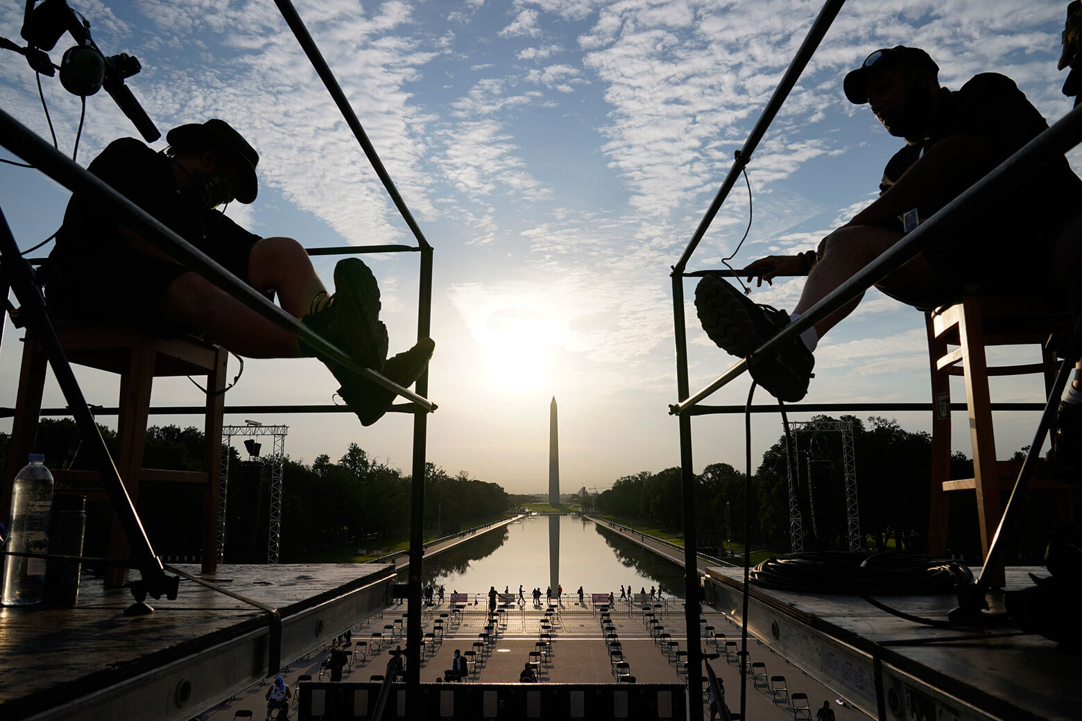 The early morning sun rises over the Washing ton Monument and the Reflecting Pool as final preparations are made for the March on Washington, Friday Aug. 28, 2020, at the Lincoln Memorial in Washington, on the 57th anniversary of the Rev. Martin Luther King Jr.'s "I Have A Dream" speech. (AP Photo/Jacquelyn Martin)