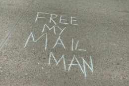 "Free my mail man" was written in chalk outside the condo building where the postmaster general lives.