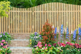 entrance and wooden fence of backyard flower garden