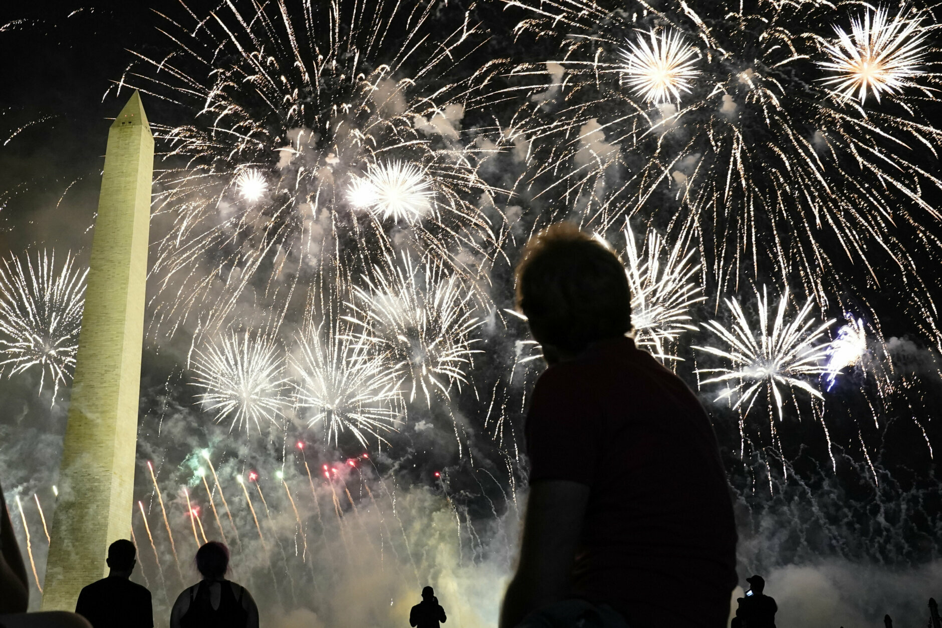 People watch fireworks near the Washington Monument on the fourth day of the Republican National Convention, Thursday, Aug. 27, 2020, in Washington. (AP Photo/Andrew Harnik)