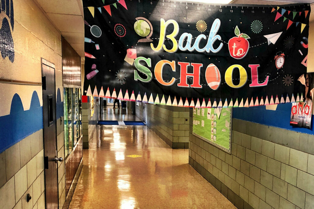 Empty school hallway with a 'back to school' banner