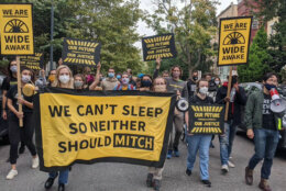 Dozens of protesters marched along the street in front of Senate Majority Leader Mitch McConnell's home in D.C.'s Stanton Park neighborhood early Thursday morning. (Courtesy Sunrise Movement)