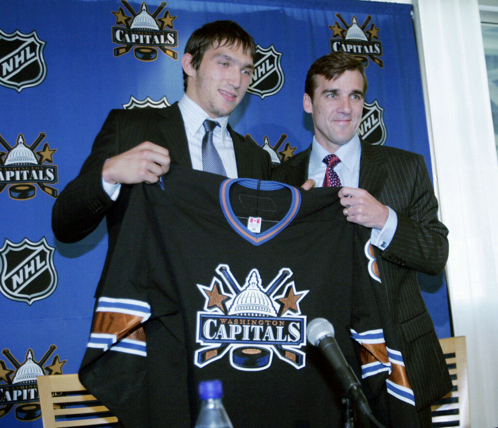 <p>A 19-year-old Ovi holds up his new team jersey with the Caps&#8217; vice president and general manager George McPhee during a September 2005 news conference at the MCI Center. He was the No. 1 draft pick in 2004 but had to wait because of the league lockout.</p>
