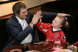 <p>Ovi high-fives his &#8220;date,&#8221; 10-year-old Ann, following a Caps game against Carolina in October 2014. Ann asked Ovechkin on a date during a skate he hosted at Kettler Capitals Iceplex, and Ovechkin surprised her by granting her request during the Capitals&#8217; final preseason game.</p>
