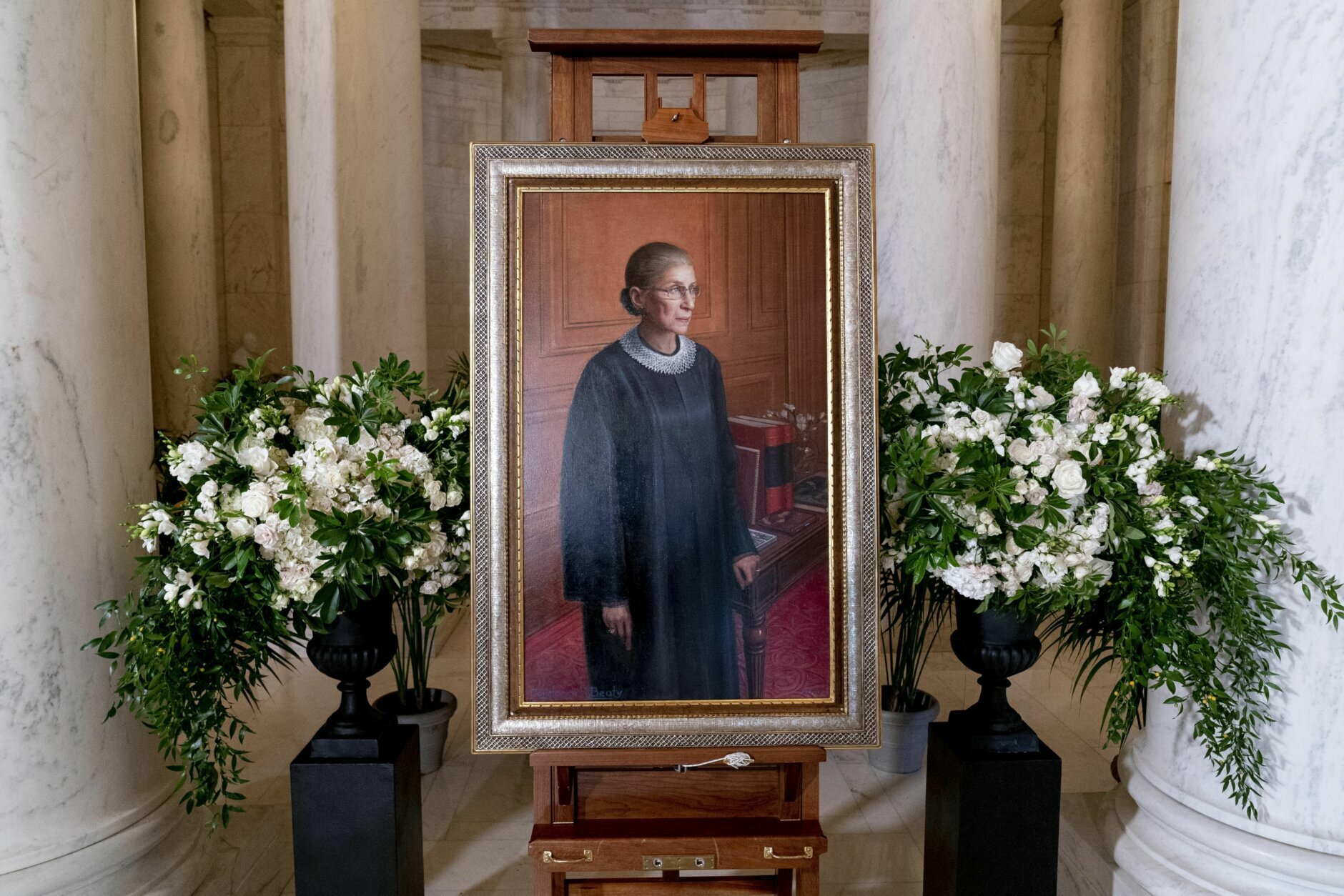 A 2016 portrait of Associate Justice Ruth Bader Ginsburg by artist Constance P. Beaty is displayed in the Great Hall following a private ceremony for her at the Supreme Court in Washington, Wednesday, Sept. 23, 2020. Ginsburg, 87, died of cancer on Sept. 18. (AP Photo/Andrew Harnik, Pool)