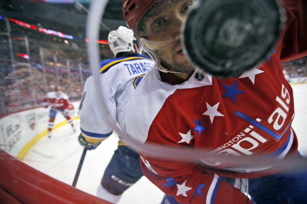 <p>Ovechkin keeps his eyes on the puck during a March 2016 game against Vladimir Tarasenko and the St. Louis Blues.</p>
