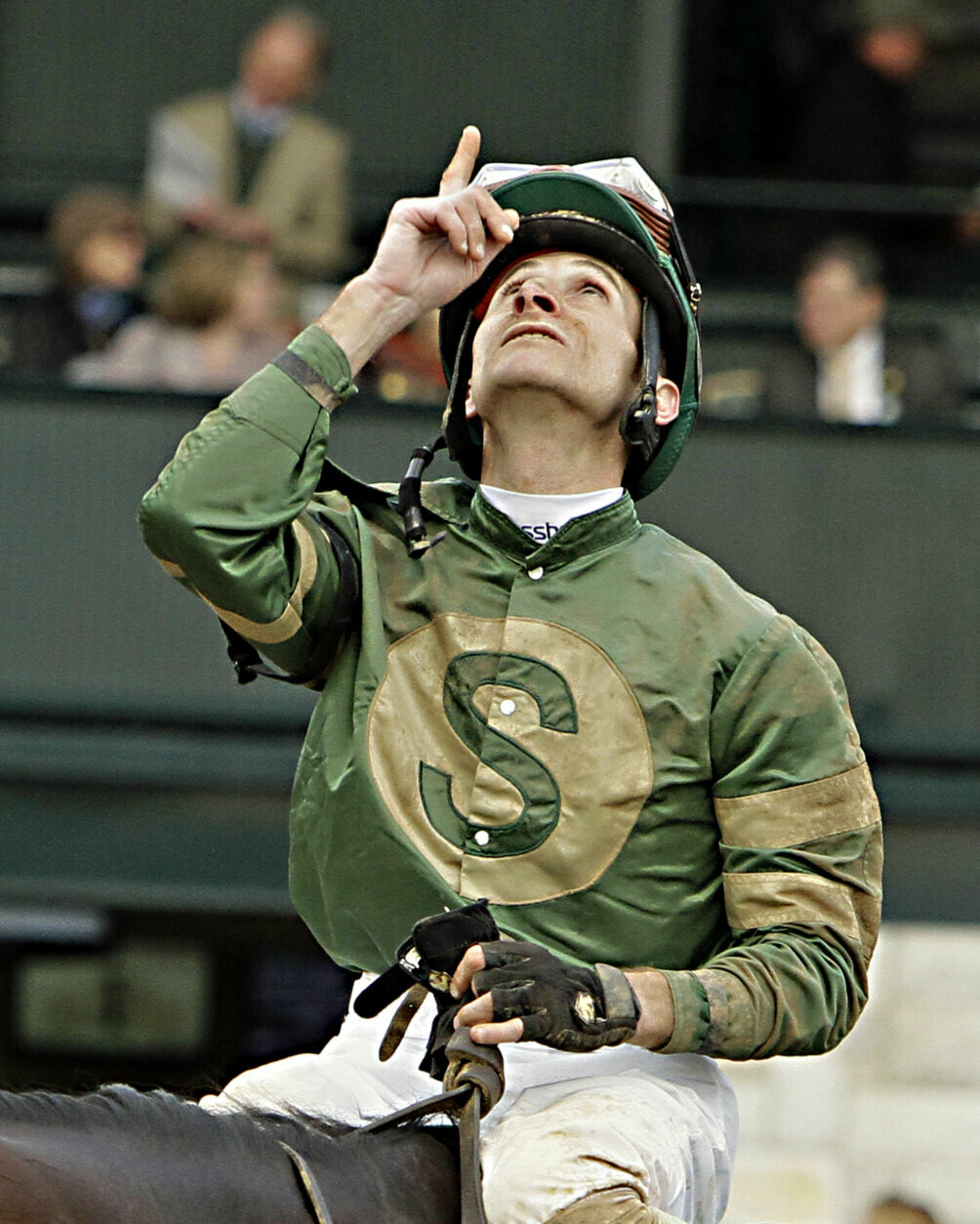 Jockey Joe Rocco, Jr., celebrates as he heads to the trophy presentation after riding Don't Tell Sophia to victory in the $500,000 Spinster Stakes horse race at Keeneland Race Course in Lexington, Ky., Sunday, Oct. 5, 2014. (AP Photo/Garry Jones)