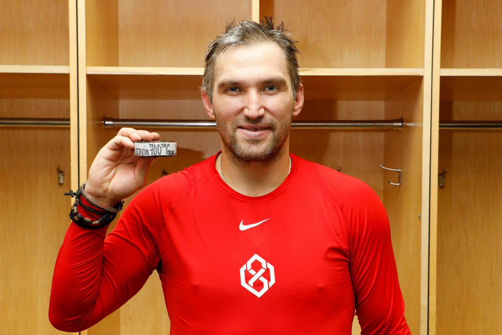 <p>Ovechkin poses with the puck that marked his 700th NHL goal — scored Feb. 22 against the New Jersey Devils in Newark.</p>
