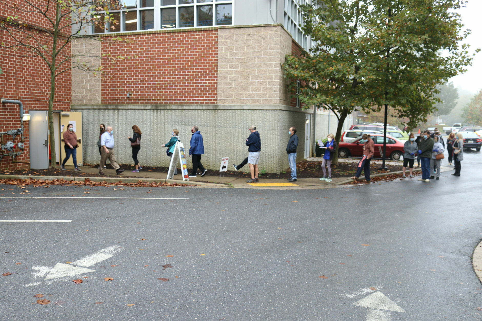Voters wait in line to enter the Pip Moyer Recreation Center, Monday, Oct. 26, 2020 in Annapolis, Md., on the first day of in-person early voting in the state. (AP Photo/Brian Witte)