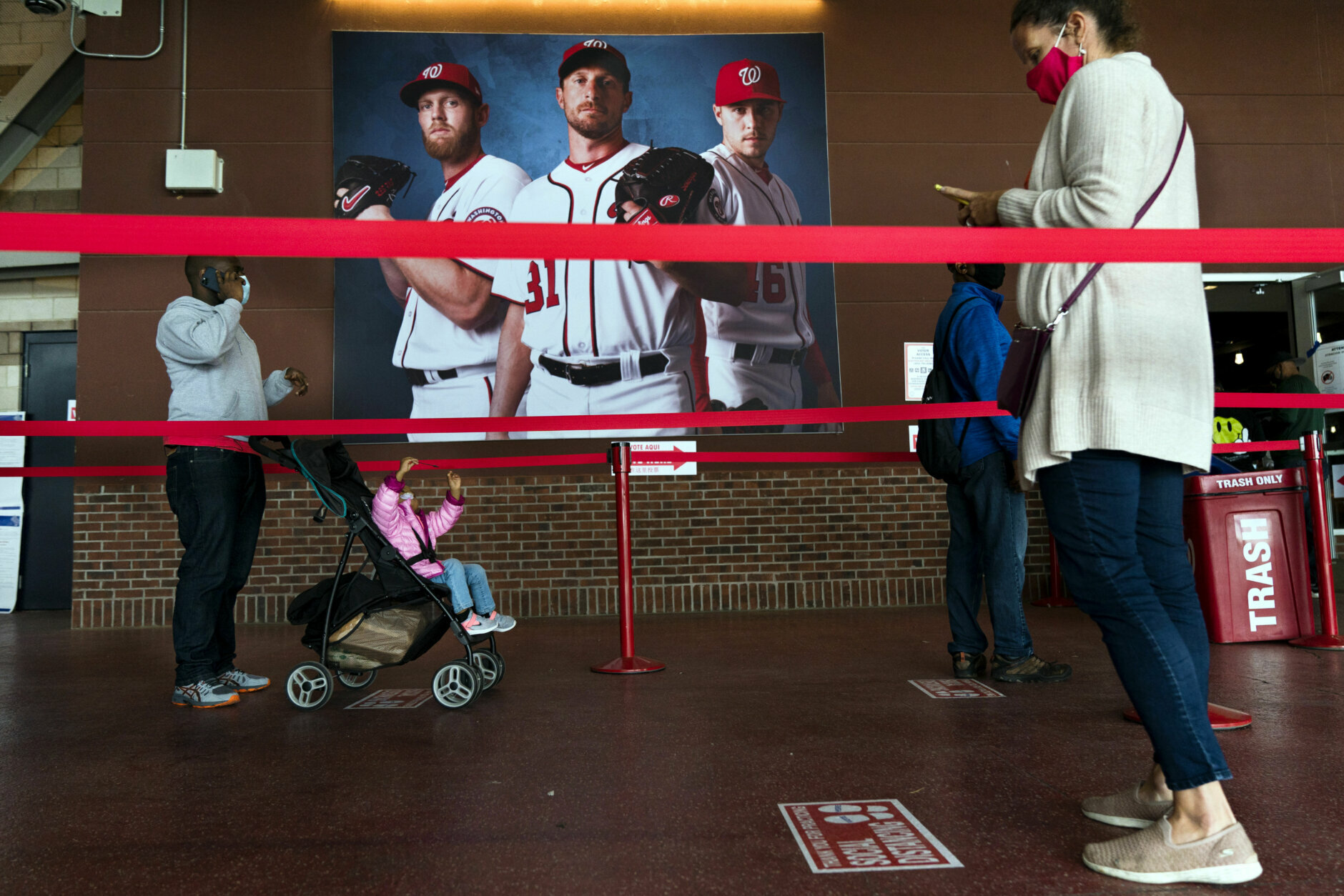 Early voting begins in the District of Columbia as voters wait in line at an early voting center at Nationals Park, Tuesday, Oct. 27, 2020, in Washington. (AP Photo/Jacquelyn Martin)