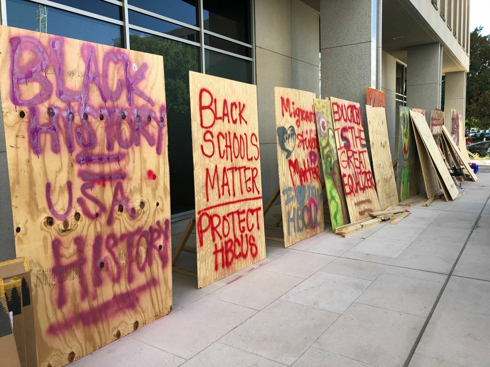 The art for the protest has been put on display by demonstrators who say they will occupy the area outside the Department of Education building in D.C. until their demands are met.