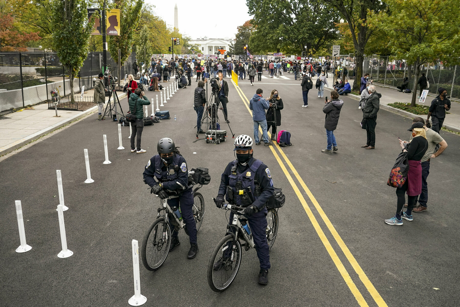 District of Columbia Metropolitan Police stand watch as demonstrators gather outside the White House, Tuesday, Nov. 3, 2020, in Washington. (AP Photo/John Minchillo)